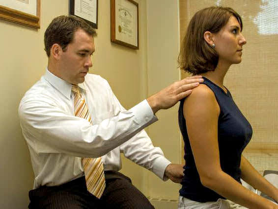 image of Dr French examining a patient's back pain